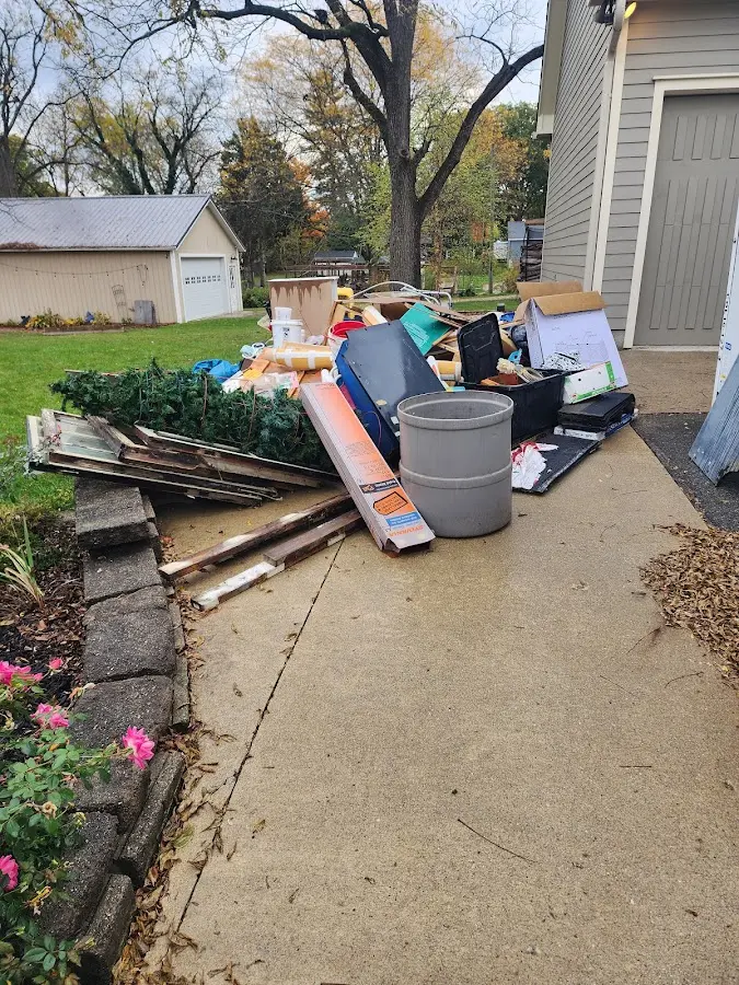 Dumpster being loaded with debris for Estate Cleanout Dumpster Rental in Stewartville